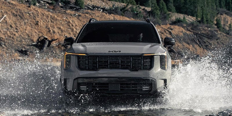 2026 Kia Sorento front grille design navigating rugged terrain with all-wheel drive capability near Batesville, AR